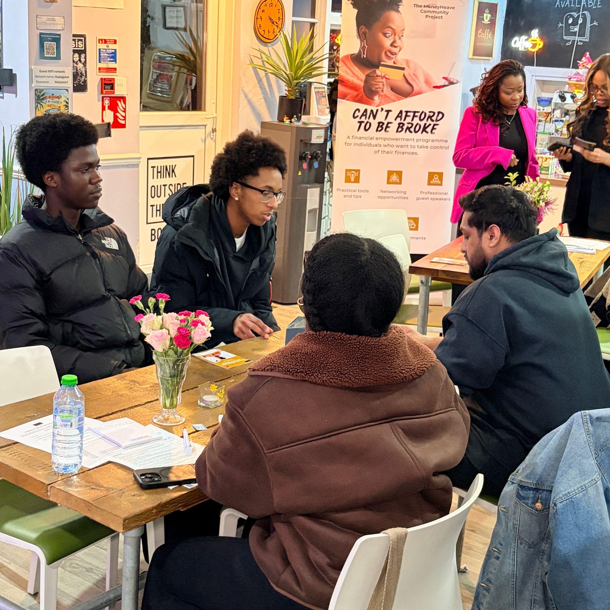 Young adults seated around a table and having a discussion